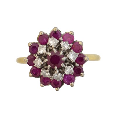 Lot 101 - A ruby and diamond cluster ring.