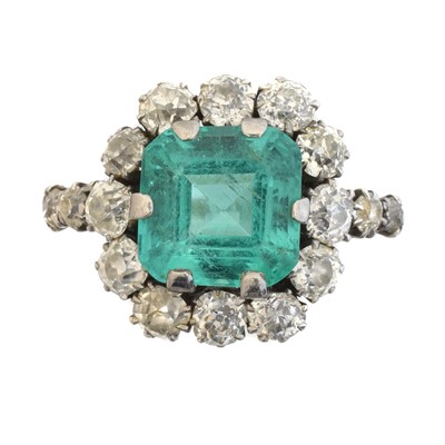 Lot An early 20th century emerald and diamond cluster ring.