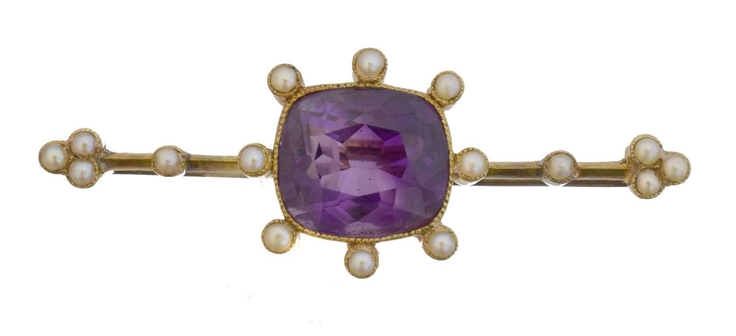 Lot 9 - An early 20th century amethyst and split pearl brooch.