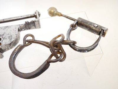 Lot 240 - Pair of hand cuffs and a bar lock (lacking the...