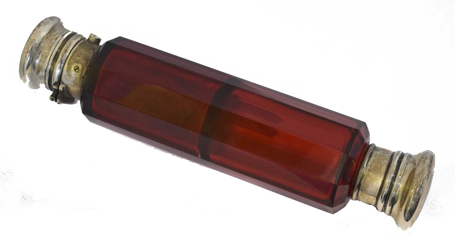 Lot 50 - A late Victorian double ended cranberry glass scent bottle.