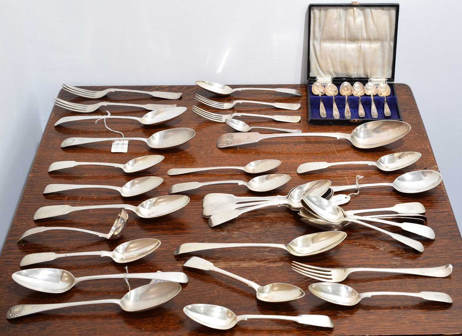 Lot 12 - A large selection of silver and white metal flatware.