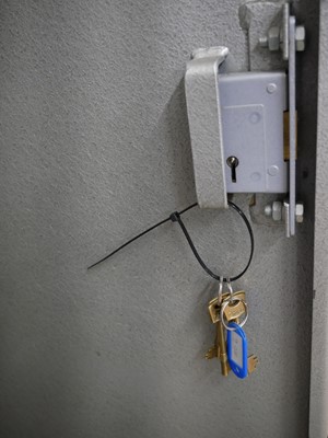 Lot 407 - Steel gun cabinet with two sets of keys.