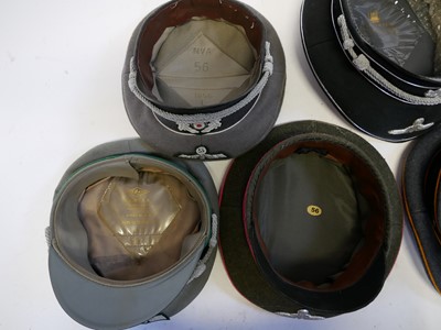 Lot 208 - Five reproduction German Third Reich peaked caps.