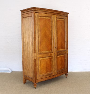 Lot 176 - A Walnut Bowfront Wardrobe from the "Spire" Range by Frank Hudson Ltd.