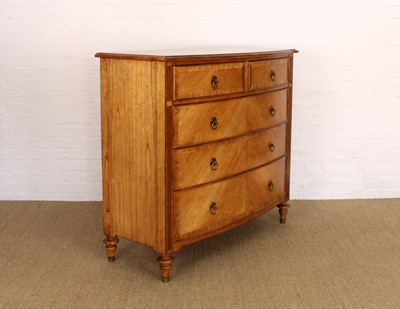 Lot 177 - A Walnut Bowfront Chest of Drawers from the "Spire" Range by Frank Hudson Ltd.