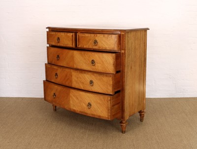Lot 177 - A Walnut Bowfront Chest of Drawers from the "Spire" Range by Frank Hudson Ltd.