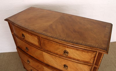 Lot 177 - A Walnut Bowfront Chest of Drawers from the "Spire" Range by Frank Hudson Ltd.