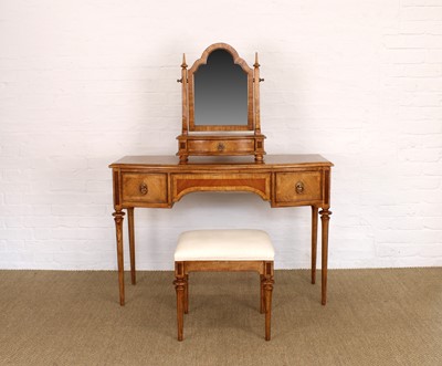 Lot 175 - A Walnut Bowfront Dressing Table, Mirror and Stool from the "Spire" Range by Frank Hudson Ltd.