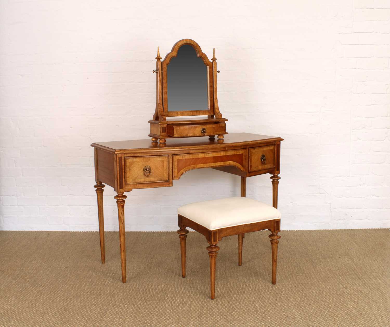 Lot 175 - A Walnut Bowfront Dressing Table, Mirror and Stool from the "Spire" Range by Frank Hudson Ltd.
