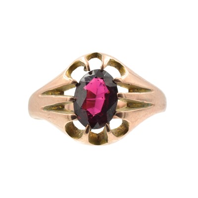 Lot A 9ct yellow gold and garnet single stone ring