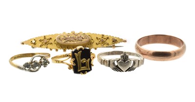 Lot A group of four rings and a brooch
