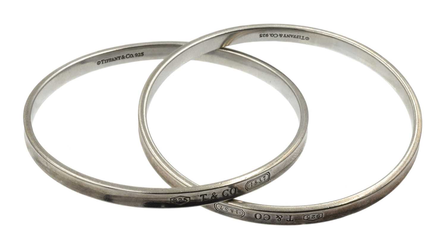Lot 25 - A sterling silver Tiffany & Co. interlocking double bangle