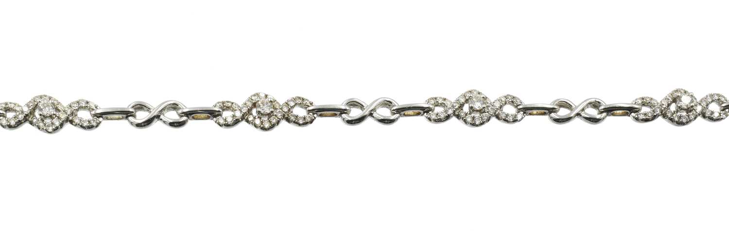Lot 23 - An 18ct gold and diamond infinity link bracelet by Goldsmiths