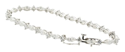 Lot 18 - A 3.50ct marquise and round brilliant cut diamond tennis bracelet, set in 18ct gold