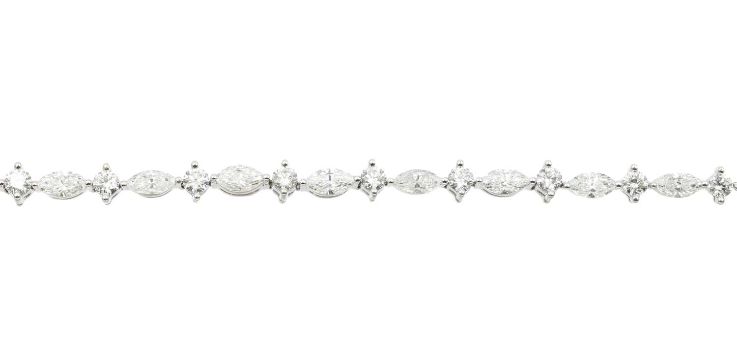 Lot 18 - A 3.50ct marquise and round brilliant cut diamond tennis bracelet, set in 18ct gold