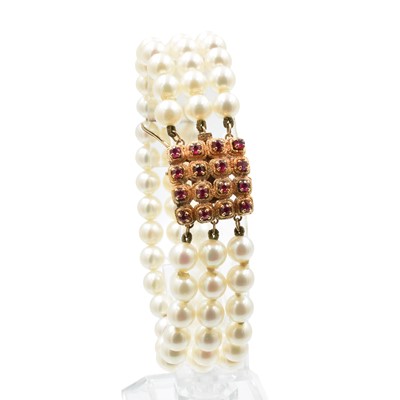 Lot A 3-row akoya pearl bracelet with a ruby clasp, set in 14ct rose gold
