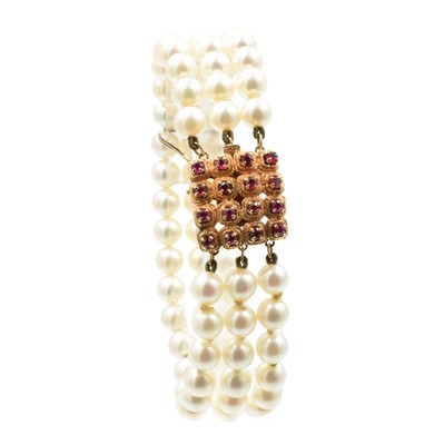 Lot A 3-row akoya pearl bracelet with a ruby clasp, set in 14ct rose gold
