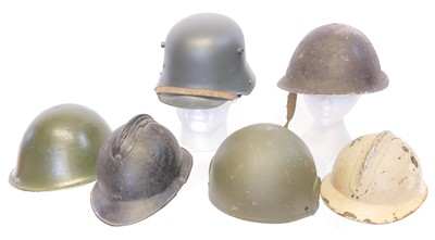 Lot Six helmets, including two French 'Adrian'...