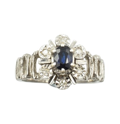 Lot 53 - An 18ct white gold, diamond, and sapphire cluster ring