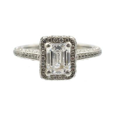 Lot 4 - A 1.01ct emerald cut diamond halo ring, set in platinum