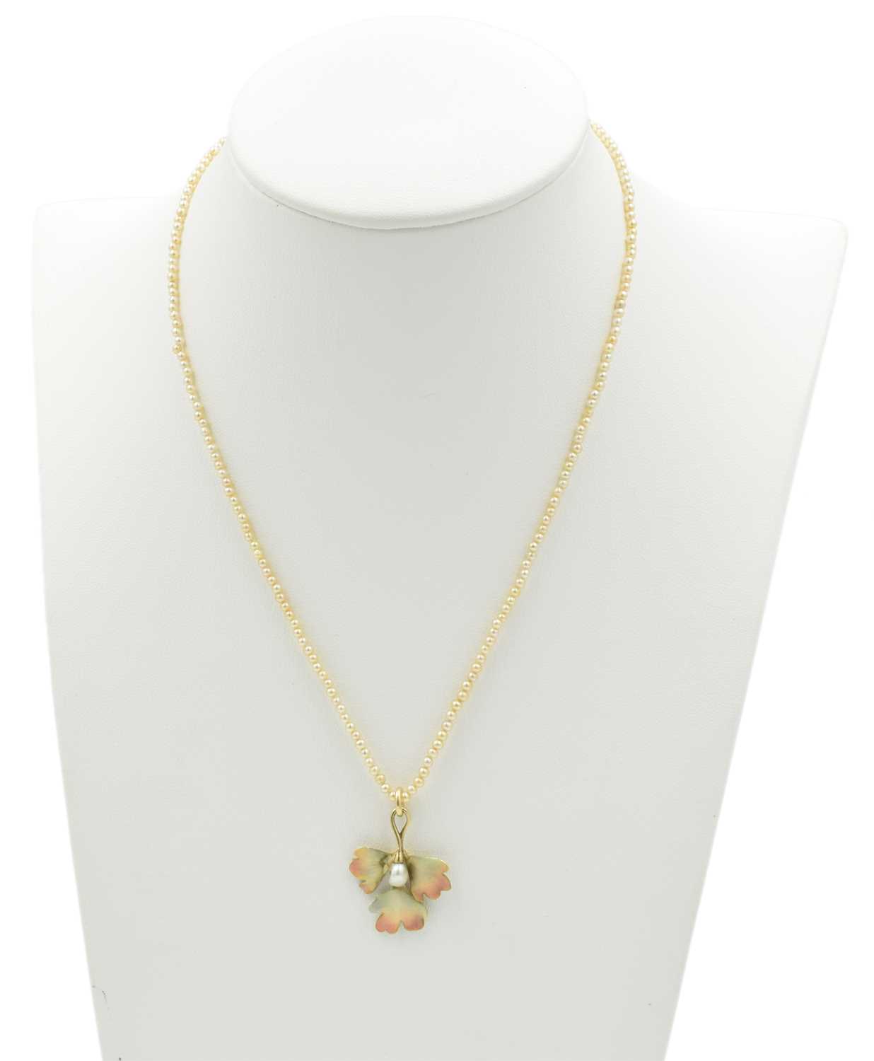 Lot A seed pearl foliage-style pendant, set in 15ct gold