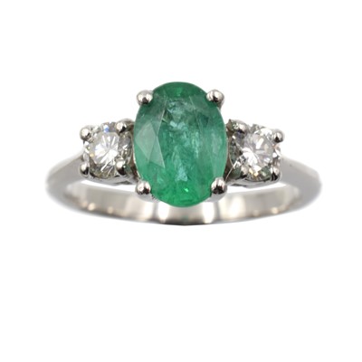 Lot 153 - An emerald and diamond three-stone ring