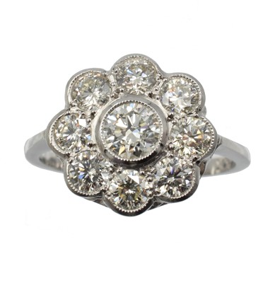 Lot 130 - A diamond and platinum daisy ring