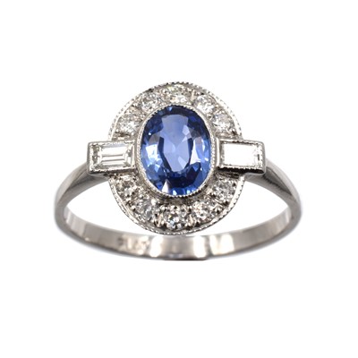 Lot 122 - A sapphire and diamond platinum cluster ring