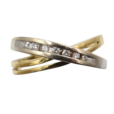 Lot 111 - A diamond cross-over two-tone ring, set in 18ct gold, by Beaverbrook's