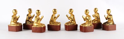 Lot 85 - A Set of Eight Tibetan Carved and Gilded Buddhist Monk Figures