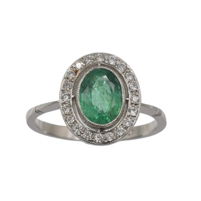 Lot An emerald and diamond halo ring, set in platinum