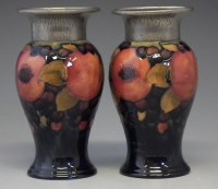 Lot 255 - Pair of Moorcroft pomegranate vases.