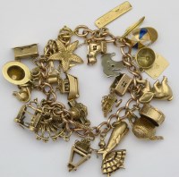 Lot 359 - 9ct gold charm bracelet, 68.8g.