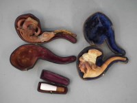 Lot 9 - Well carved Meerschaum pipe in the form of a Viking head and another carved in the shape of a Dragons claw, and a cigar holder.