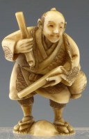 Lot 201 - Japanese ivory netsuke of a man with nunchaku sticks.