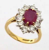 Lot 282 - Ruby and diamond oval cluster ring.