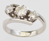 Lot 290 - Three stone diamond cross-over ring, the setting