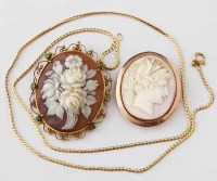 Lot 267 - Cameo pendant set with emeralds on chain and an oval cameo brooch (2).