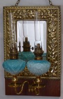 Lot 17 - Embossed brass mirror with two oil lamps.
