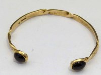Lot 349 - 9ct gold slave bangle with two red stones.