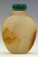Lot 187 - Russet and white jade snuff bottle carved with
