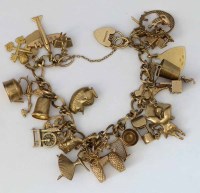 Lot 277 - 9ct gold charm bracelet, 63.1g.