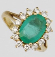 Lot 287 - Emerald and diamond oval cluster ring.
