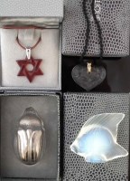 Lot 57 - Two Lalique boxed necklaces, modelled as a Star of David, the other with two cherubs, also two other models of a Scarab and a fish, both with boxes, (