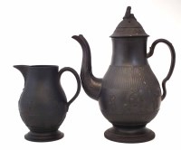 Lot 101 - Black basalt coffee pot, moulded with figures