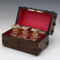 Lot 18 - Rosewood cased three bottle scent set.