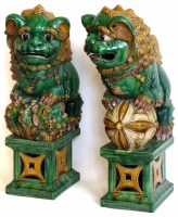 Lot 282 - Pair of green and yellow lions of fo.
