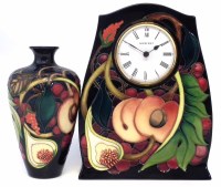 Lot 267 - Moorcroft clock and a vase, decorated with Queens