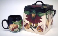 Lot 272 - Moorcroft box and cover and a cup, decorated with
